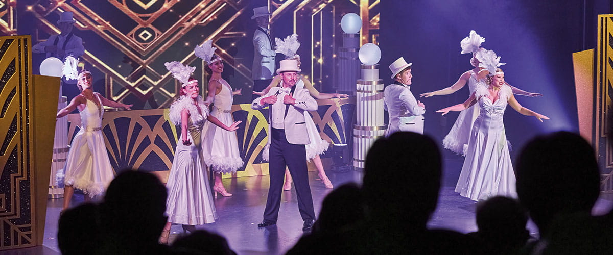 Performers on stage in the Playhouse on Spirit of Adventure